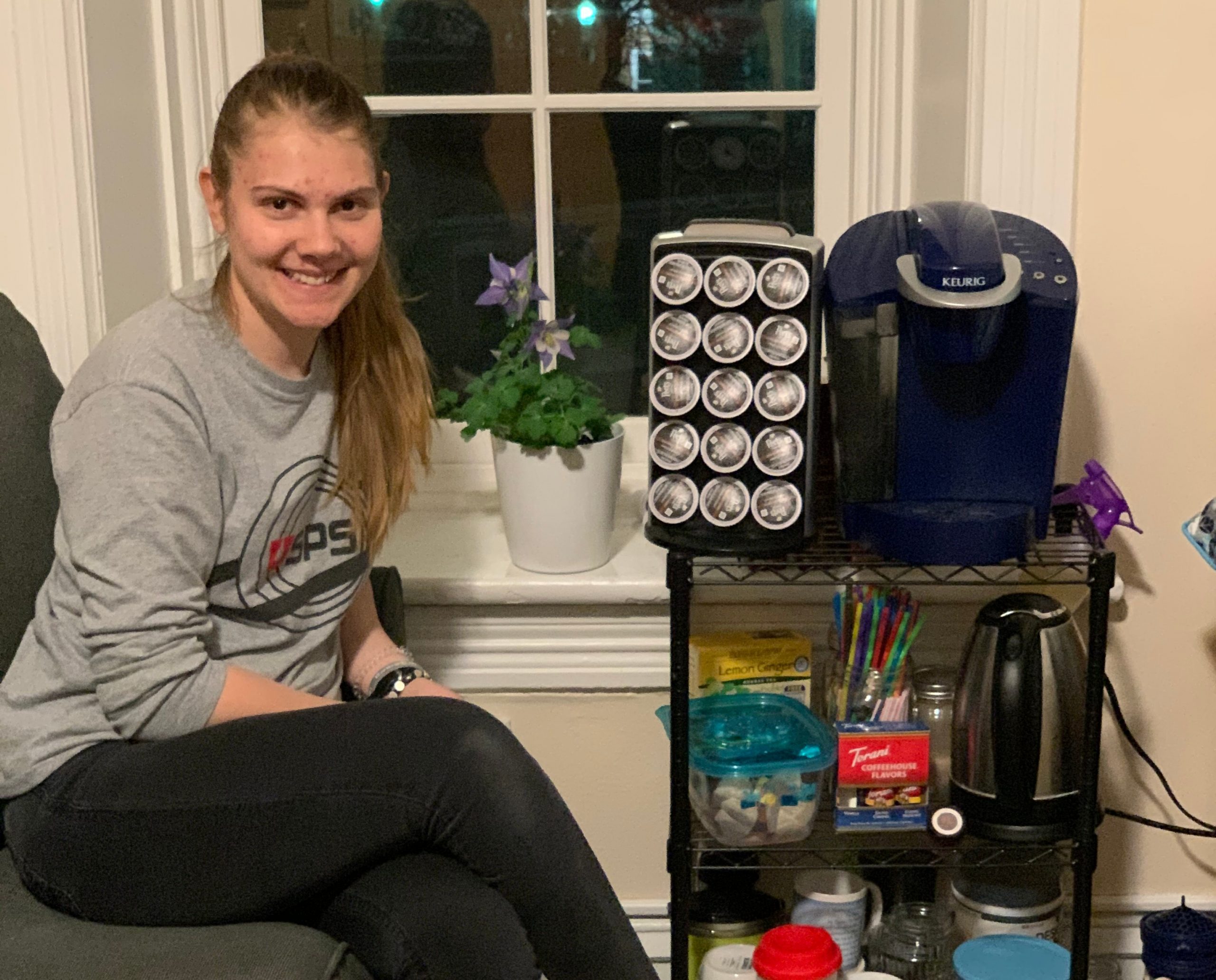 Student with coffee and tea station in their room